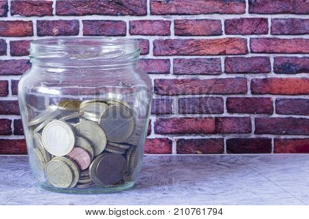 A Transparent Jar With Many Coins Saved
