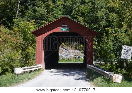 A red wooden covered bridge in Vermont