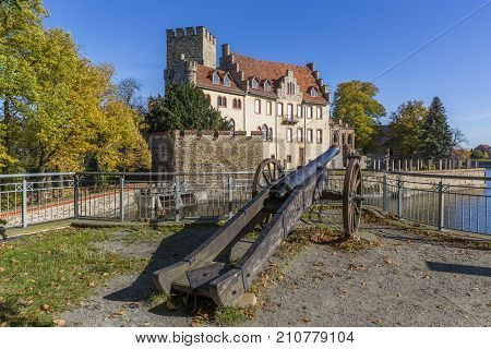 Flechtingen water castle with a cannon in the foreground in Saxony-Anhalt, Germany