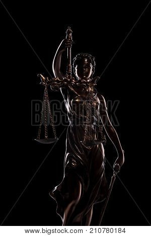 goddess iustitia statue on black background, justice concept