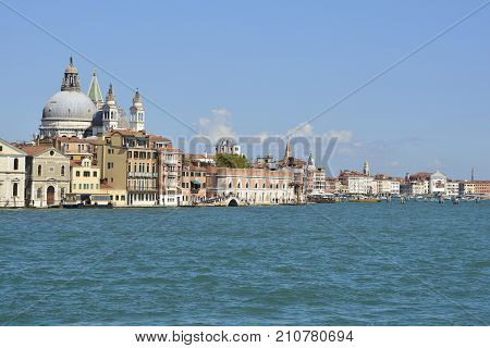 A view of the island of Dorsodoro in Venice taken from the island of Giudecca across the Giudecca Canal. The church of Santa Maria Della Salute (Saint Mary of Health) can be seen towering above the other buildings