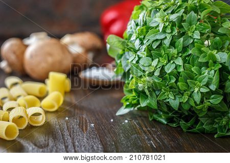 Bazil leaves on kitchen over wooden table