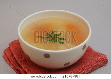 Spicy homemade soup served in pottery bowl
