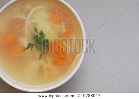 Bowl of chicken soup with vegetables and