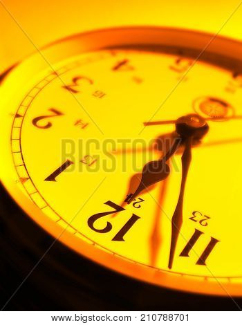 CLOSE UP OF CLOCK FACE WITH HANDS POINTING TOWARDS TWELVE O'CLOCK