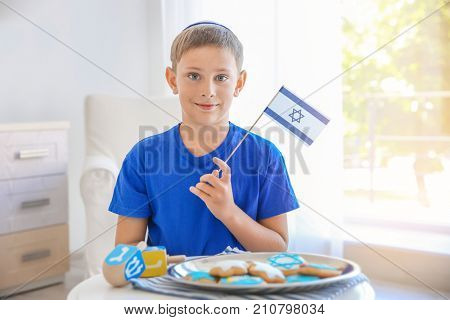 Jewish boy with flag at home