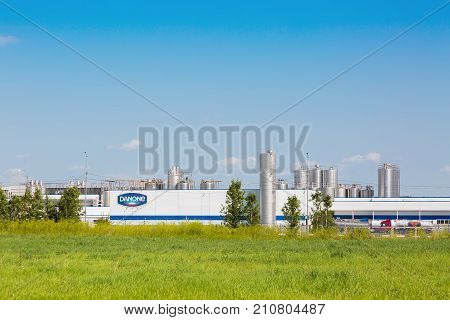 MOSCOW REGION RUSSIA - AUGUST 2017: Danone factory in Russia with green grass and blue sky.