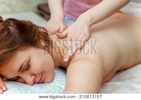 Beautiful young girl having massage in spa salon