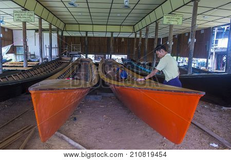 INLE LAKE MYANMAR - SEP 07 : A Burmese man building a boat in Inle lake Myanmar on September 07 2017 inle Lake is a freshwater lake located in Shan state