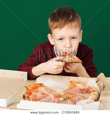 Children Eat Italian Pizza In The Cafe. School Boy Eating Pizza Slice From The Box At Fast Food Rest
