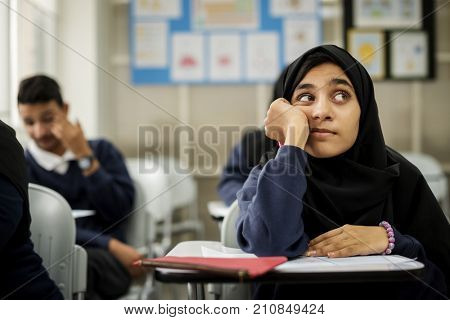 diverse muslim children studying in classroom