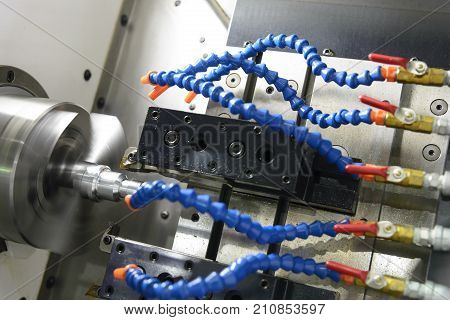CNC lathe machine (Turning machine) cutting the metal screw thread part with the cooling tube .the cnc cooling component with the sample part.