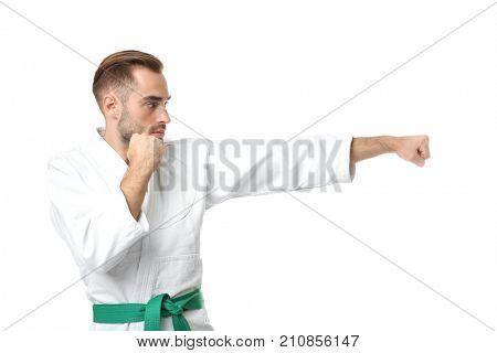 Young man practicing karate on white background
