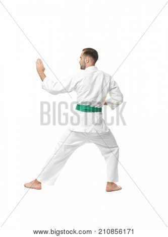 Young man practicing karate on white background