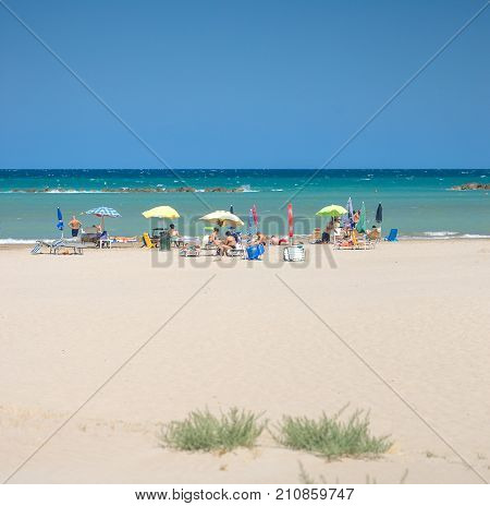 White Beaches Italy. Sea Sky People Umbrellas Sun Beds.