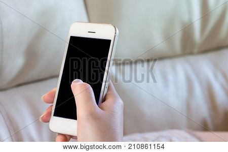 Woman Using A Smart Phone On Sofa