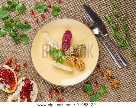 Georgian cuisine. Spinach appetizer phali with pomegranate seeds