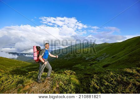 Hiking in the mountains with a backpack in the summer.