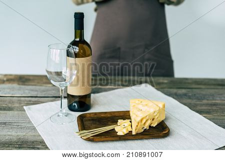 Bottle Of Wine With Empty Glass And Cheese