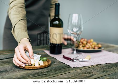 Taster Taking Piece Of Brie Cheese