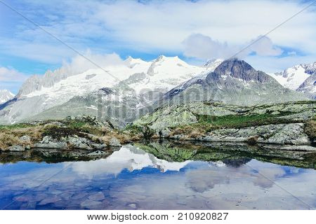Mountain lake in Switzerland. Idyllic landscape with clear mountain lake in the Alps.