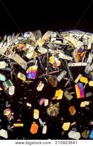 microscopic shot showing colorful microcrystals in polarised light