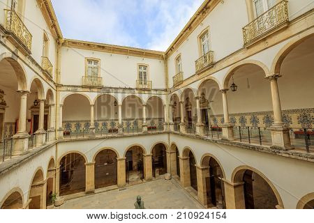 Coimbra, Portugal - August 14, 2017: cloister inside University of Coimbra, the Europe's oldest university founded in 1290. Unesco Heritage Site and most important tourist attraction in Coimbra.