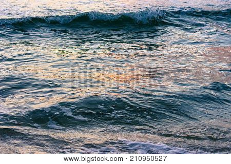 background texture - waves reflecting colors from the morning sky