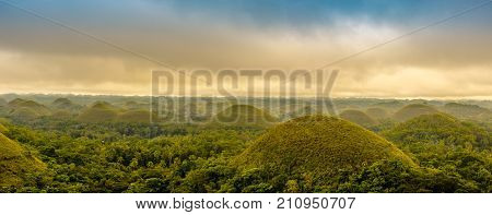Scenic View Of The Unesco Site Of Chocolate Hills In Bohol, Philippines, With Clouds And Sun