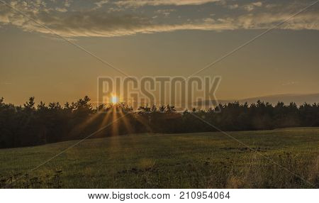 Sunset near Dominova skalka in Slavkovsky Les mountains in autumn evening