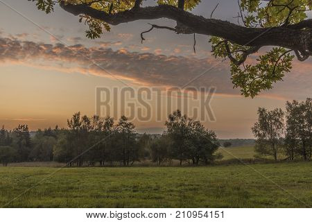 Sunset near Dominova skalka in Slavkovsky Les mountains in autumn evening
