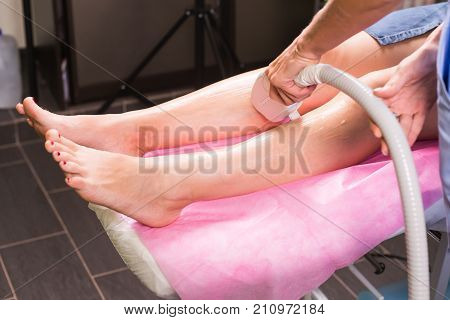 Hair removal cosmetology procedure from a therapist at cosmetic beauty spa clinic. Laser epilation and cosmetology