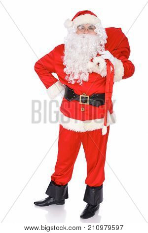 Santa Claus carrying big bag. Isolated on white background. Full length portrait.