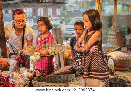 Punakha, Bhutan - September 10, 2016: Tourist Shopping At A Local Bhutanese Street Bazaar With Yello