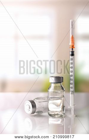 Vials And Syringe On White Table With Background Windows Vertical