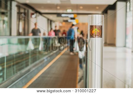 Defocused Background Of People Standing On Moving Walkway Or Travelator Or Autowalk In Modern Interi