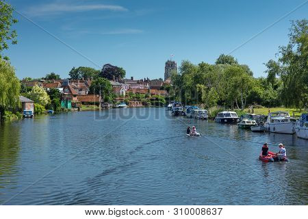 Beccles, United Kingdom - June 22, 2019: People In Small Boats Travelling Along The River Waveney In