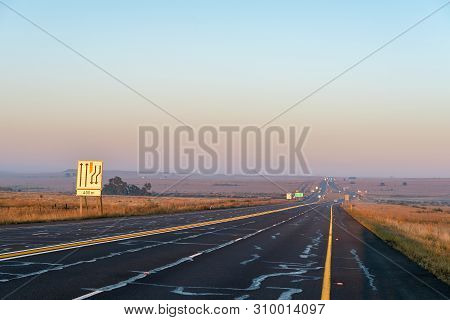 The Sun Is Rising Over Road N1 At The Verkeerdevlei Junction North Of Bloemfontein, South Africa