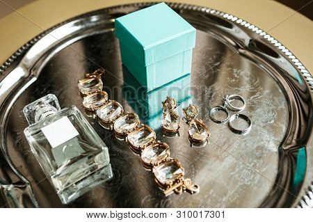 Various Wedding Accessories, Including Wedding Rings, Bracelet And Perfume.