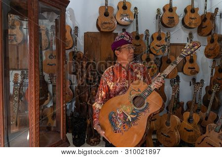 Gianyar,bali/indonesia-may 30 2019: I Wayan Tuges, The Owner Of The Tuges And Blueberry Carving Guit