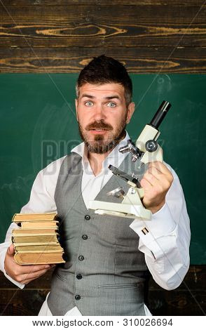 Happy Male Teacher Holds Microscope. Education, Research, Knowledge, Technology. Student Doing Resea