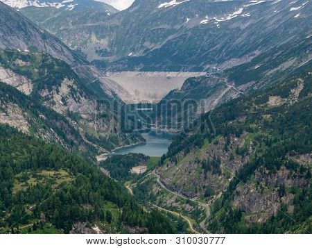 Dam And Reservoir Of A Hydroelectric Powerplant In Stunning Alpine Landscape - Maltastaudamm And Kol