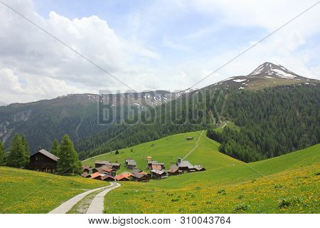 Village Obermutten And Muttener Horn, Mountain In Switzerland.