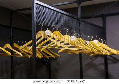 Bright Wooden Hangers With Numbers In Empty Cloakroom Or Checkroom Or Wardrobe
