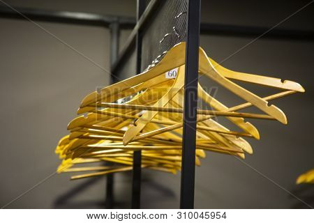 Bright Wooden Hangers With Numbers In Empty Cloakroom Or Checkroom Or Wardrobe