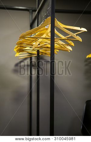 Bright Wooden Hangers With Numbers In Empty Cloakroom Or Checkroom Or Wardrobe