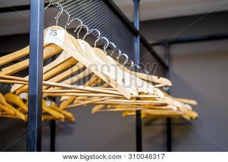 Bright Wooden Hangers With Numbers In Empty Cloakroom Or Checkroom Or Wardrobe