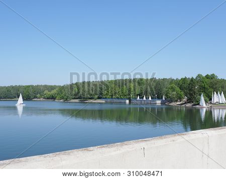 Goczalkowice, Poland On May 2019: Part Of Wall And White Yachts On Landscapes Of Artificial European