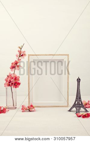 Mock Up With Empty Picture Frame, Decorative Effel Tower And Pink Tender Spring Flowers.