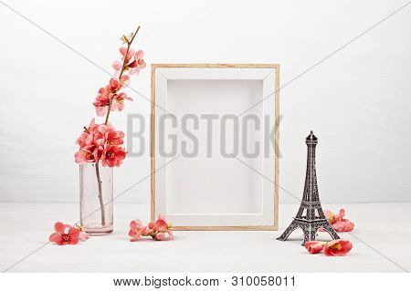 Mock Up With Empty Picture Frame, Decorative Effel Tower And Pink Tender Spring Flowers.